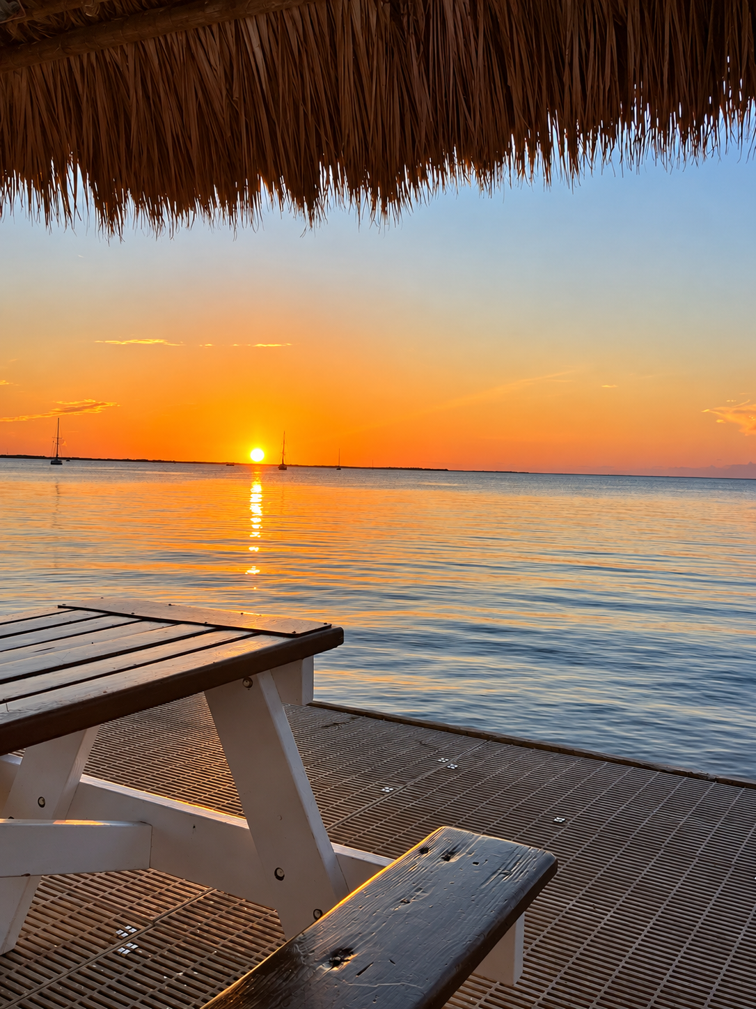 Thatched Palapa Sunset Over Calm Waters.png