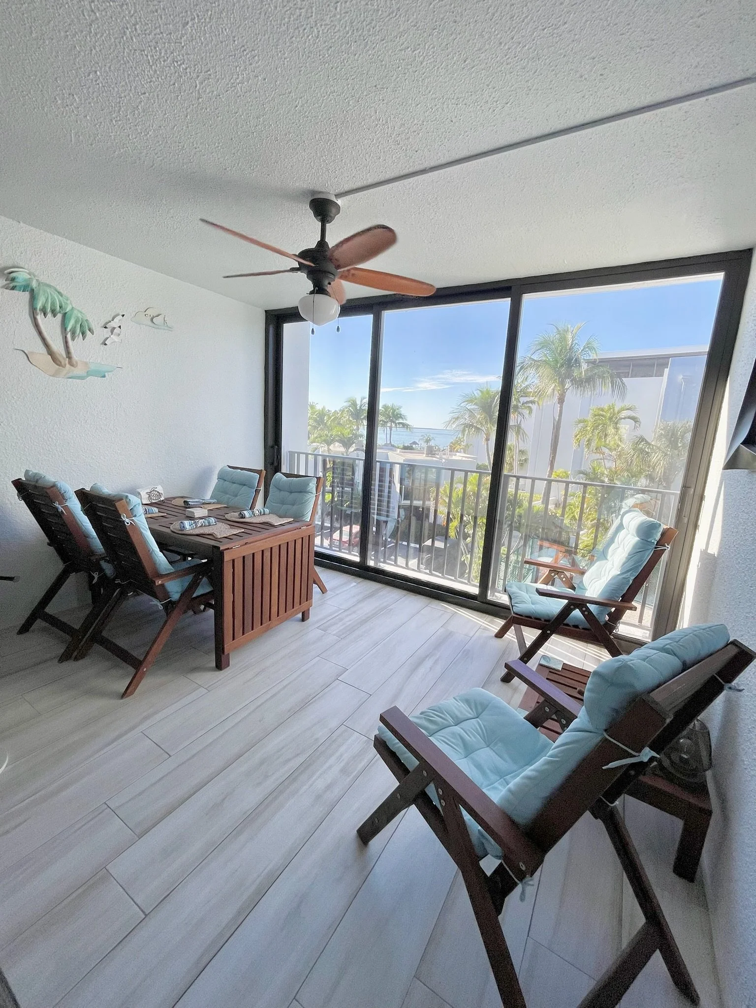 The enclosed balcony at our Moon Bay Key Largo vacation rental offers beautiful views of Blackwater Sound, comfortable seating, and the flexibility to enjoy fresh ocean breezes or air-conditioned comfort year-round.