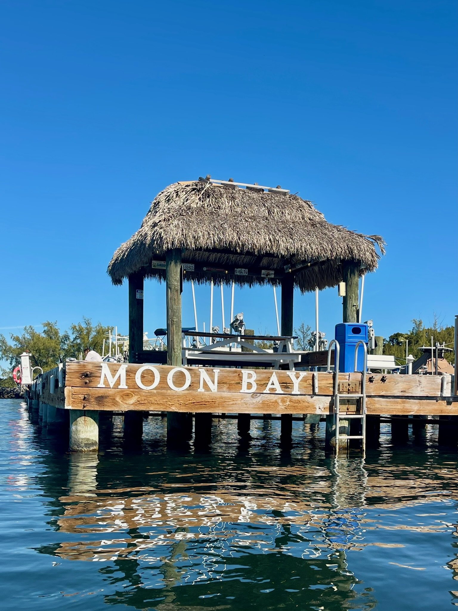 The Moon Bay marina tiki is a favorite gathering spot in Key Largo for fishing, relaxing, boating, and enjoying the peaceful waterfront setting on Blackwater Sound.
