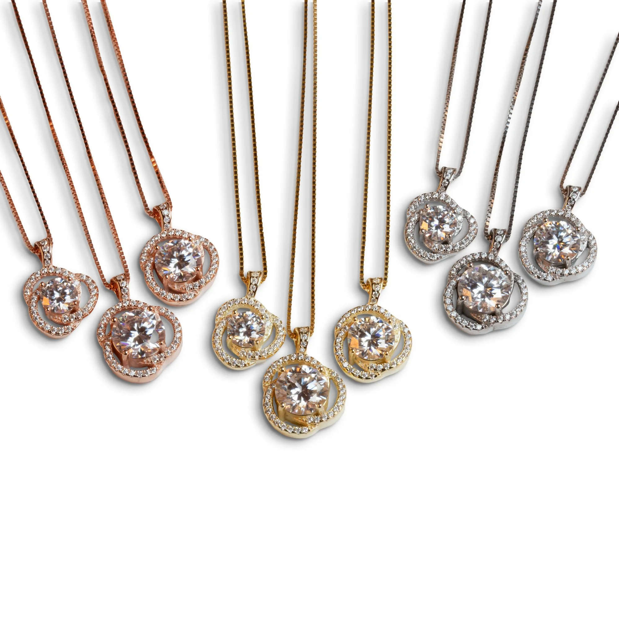 Collection of six necklaces with round diamond pendants in rose, yellow, and white gold, each surrounded by smaller diamonds.