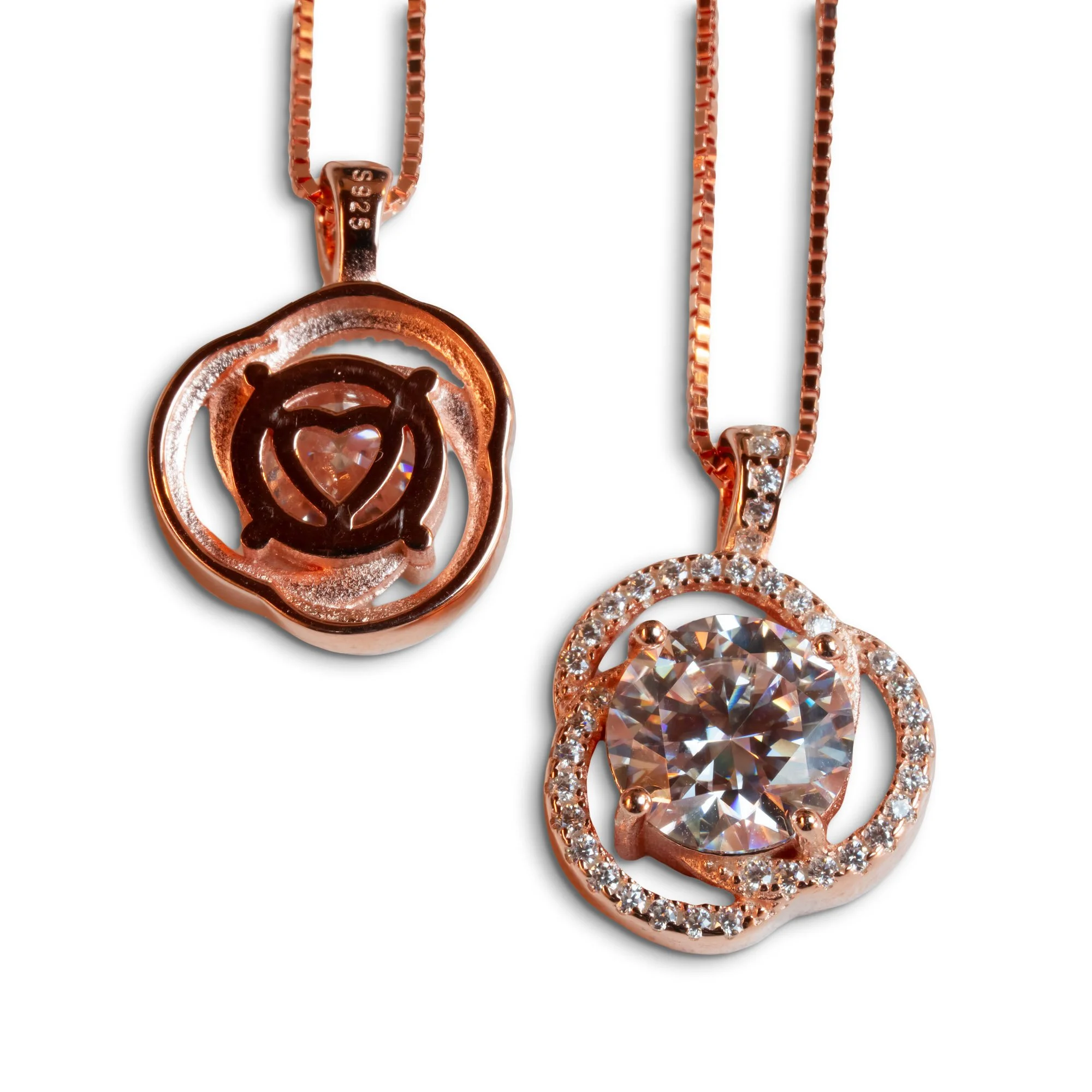 Two rose gold necklaces featuring circular pendants with sparkling stones, one with a large central gem and the other with a cut-out design.
