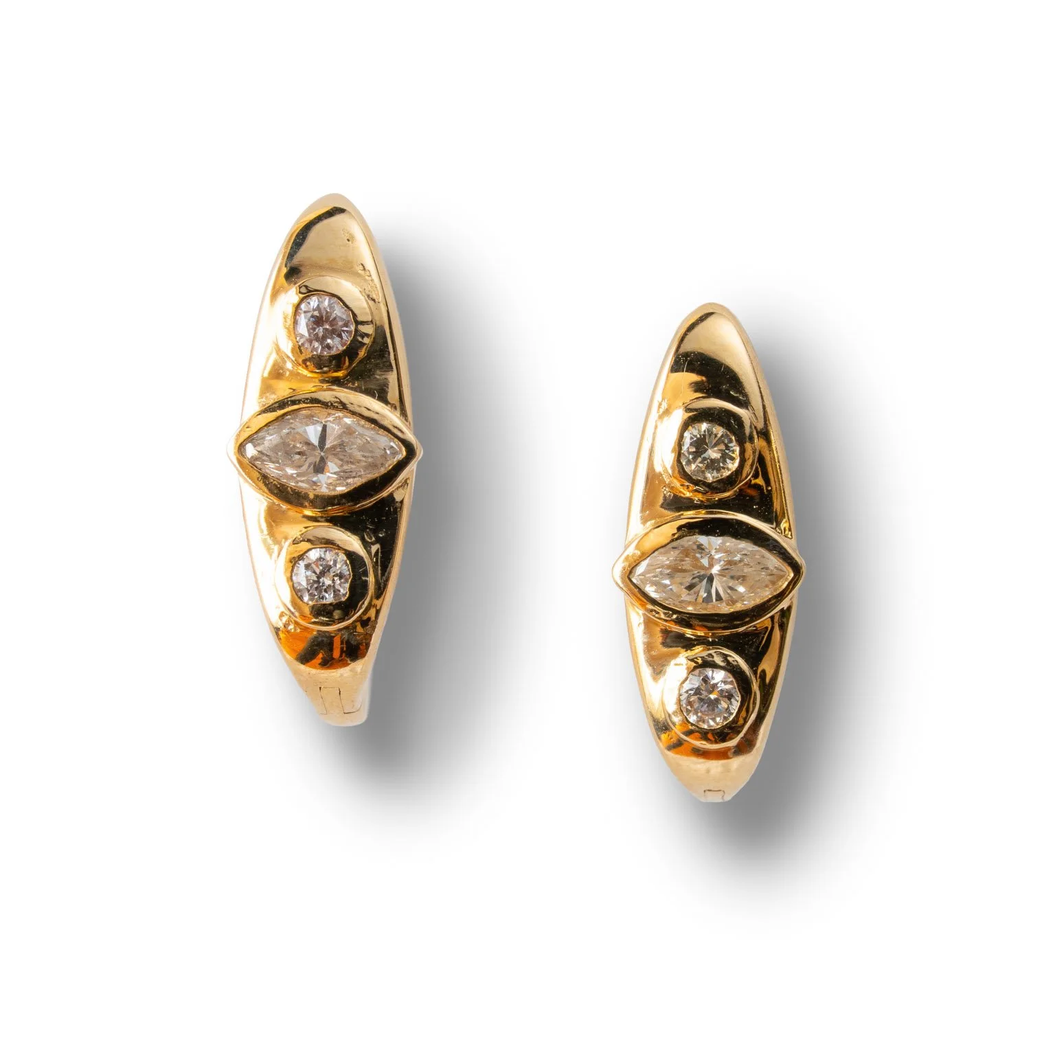 Pair of gold earrings with three diamonds each, featuring a large marquise-shaped diamond in the center and two round diamonds, one above and one below it, set against a white background.