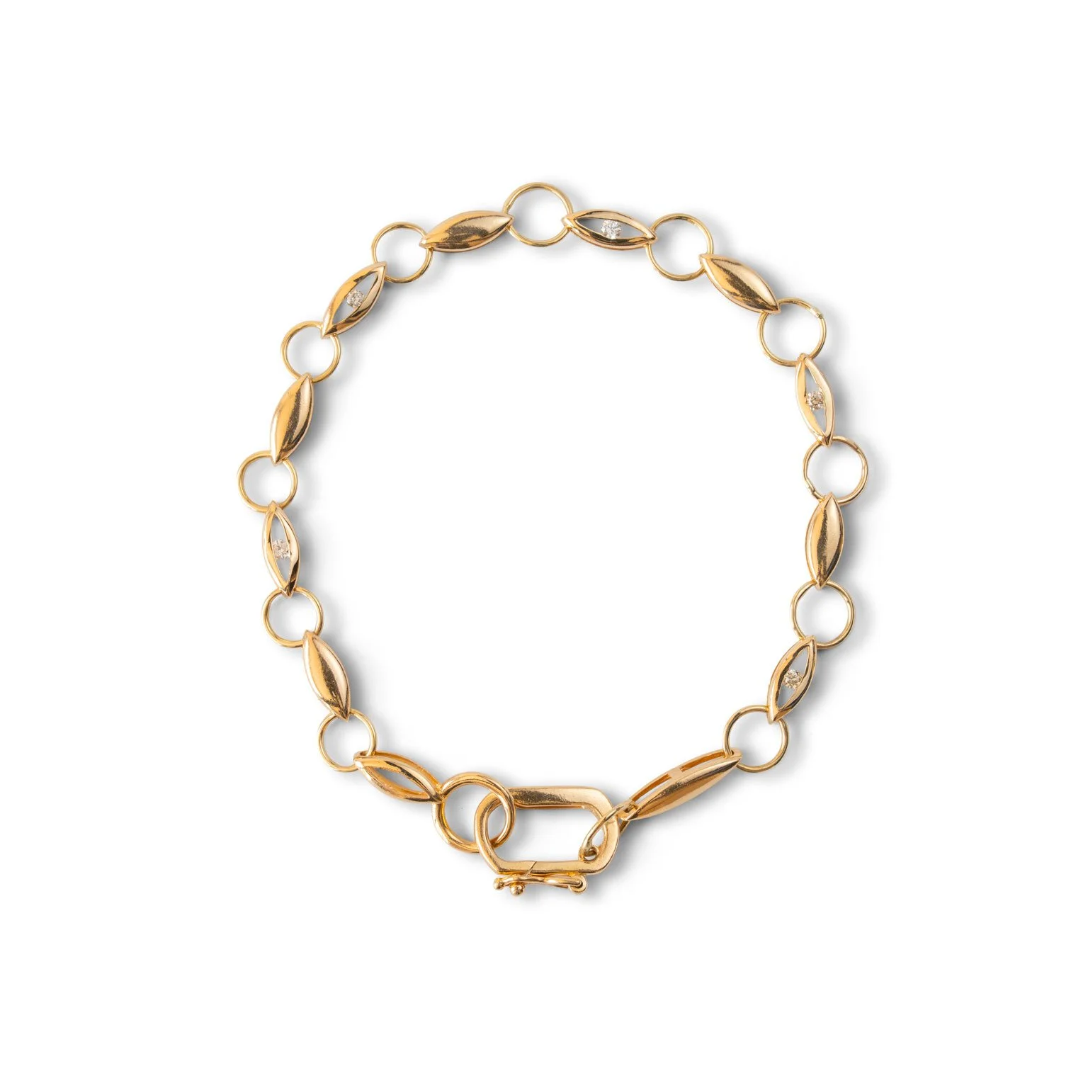 Gold chain bracelet with leaf-shaped links and small embedded gemstones