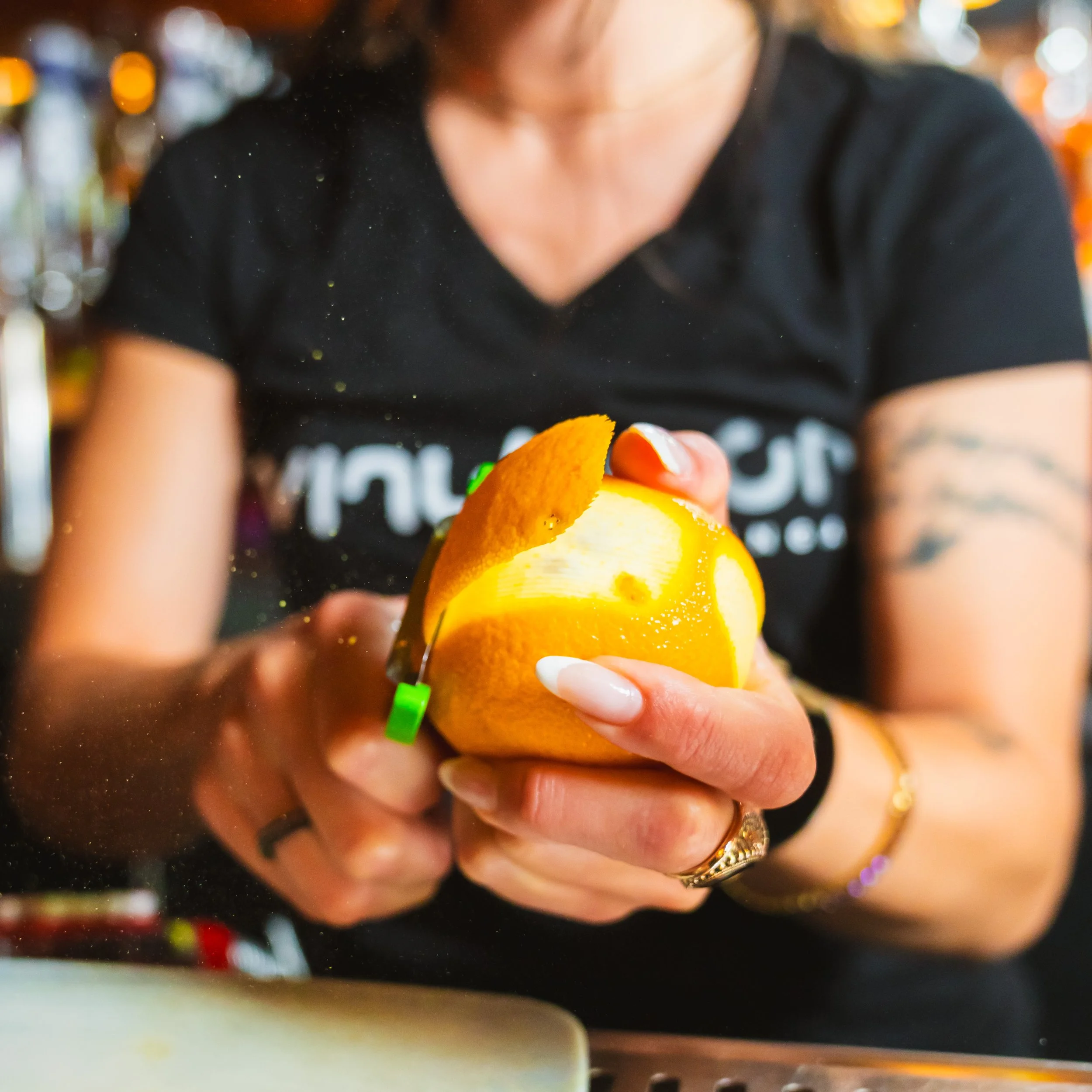 Bartender peeling an orange - Creative Media Collective
