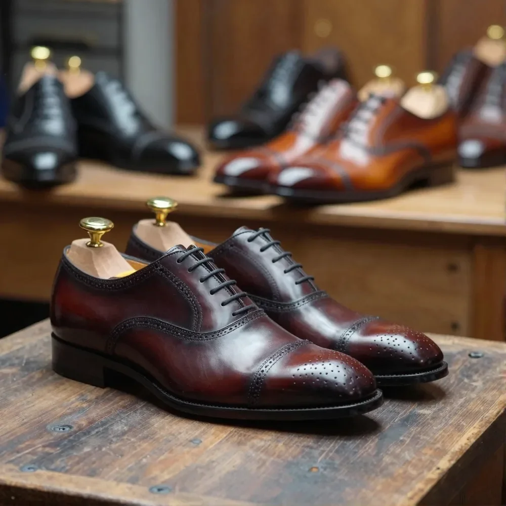 A pair of polished brown leather men's dress shoes on a wooden display table in a shoe store, with other shoes in the background.