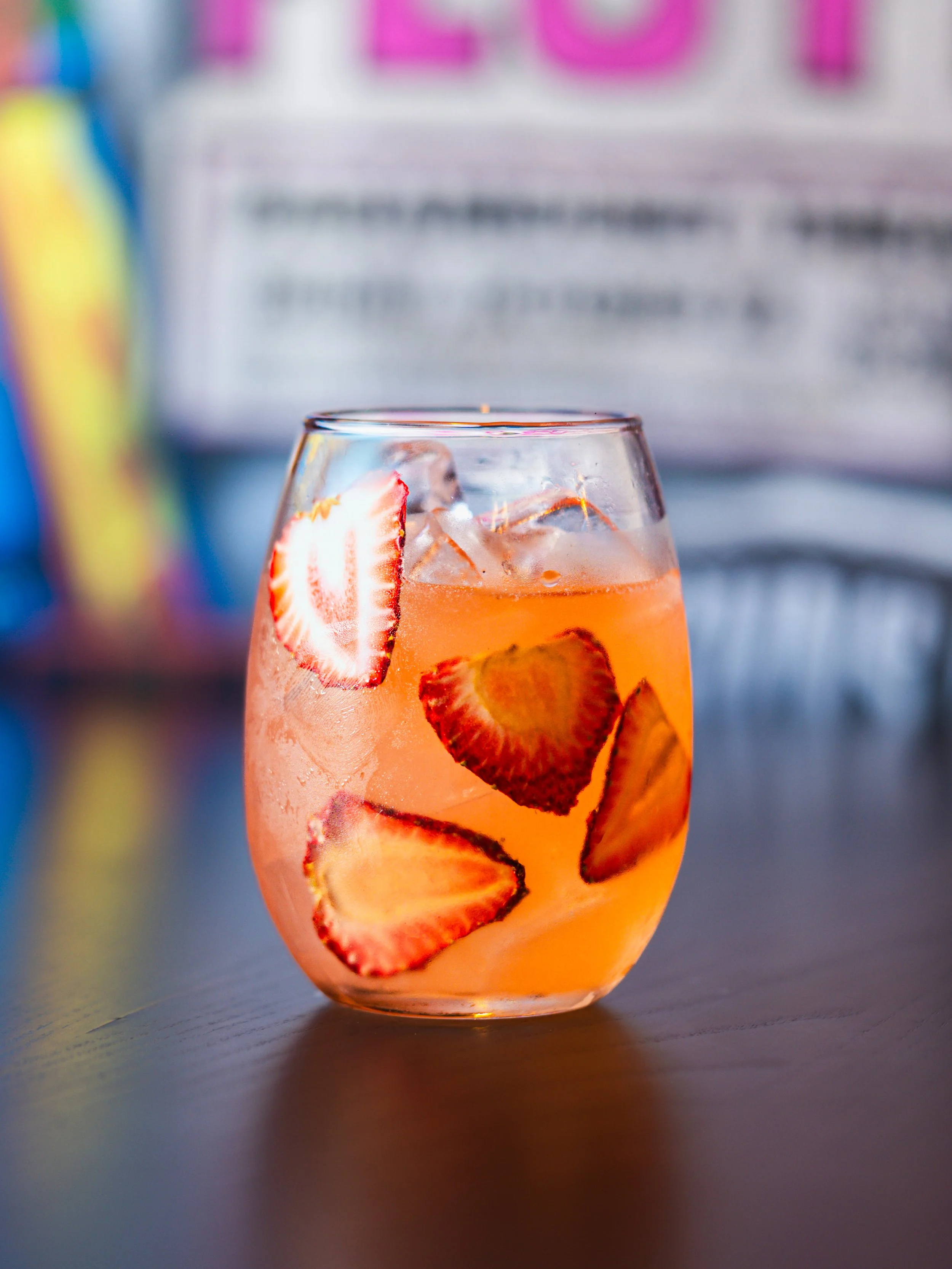 Eggs Benedict with a soft-boiled egg on top of lettuce, on an English muffin, served with hollandaise sauce on a dark plate.