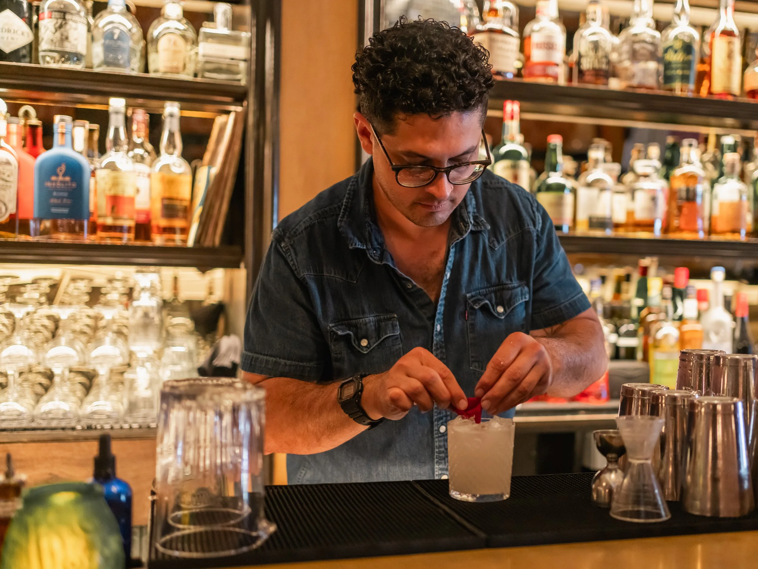 Open-faced sandwich with a poached egg, cucumber slices, radish slices, microgreens, and spread on whole grain bread, served on a gray plate.