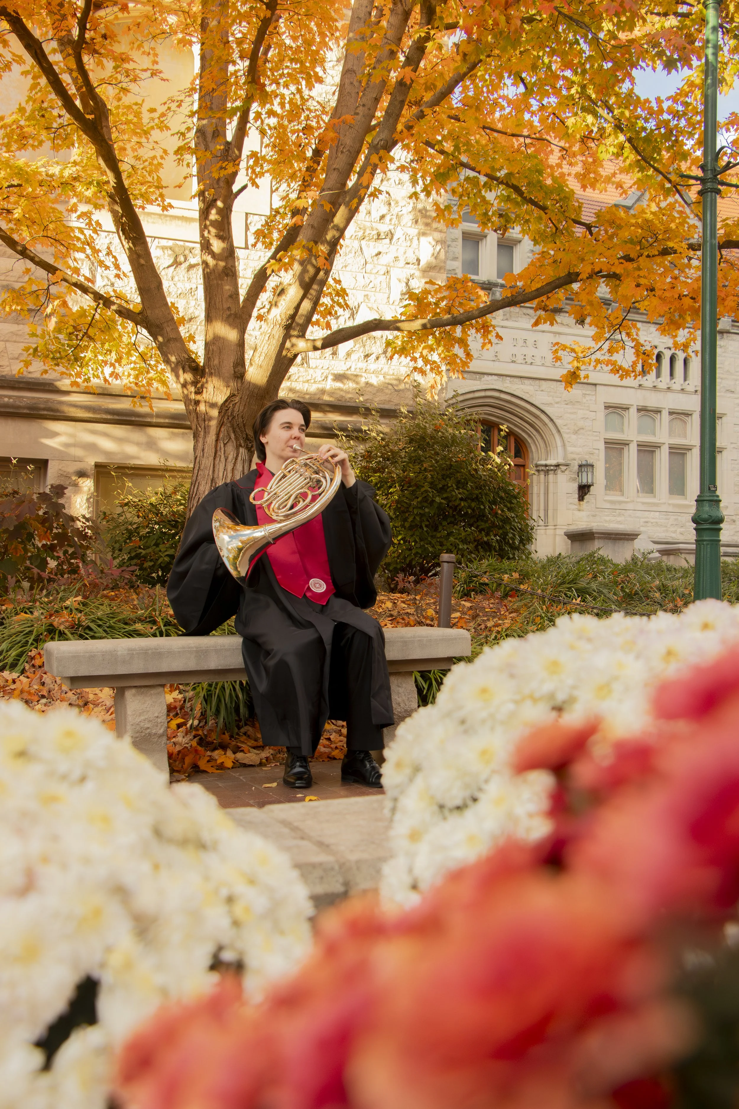 Another graduate sits surrounded by colorful fall foliage. What a fun session this was!