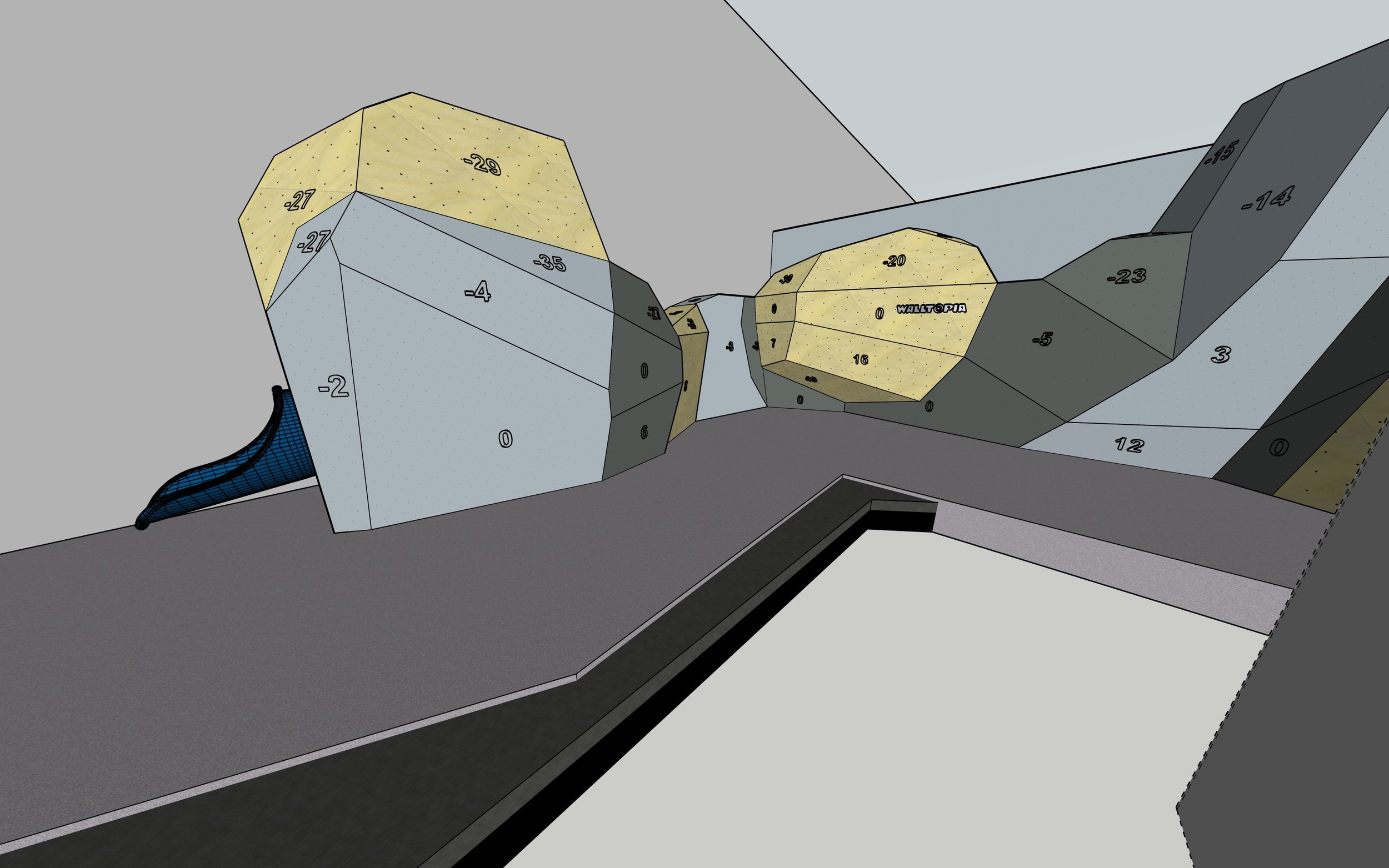 An indoor bouldering gym with various climbing walls and holds, including a large overhanging section and a flat wall with color-coded holds.