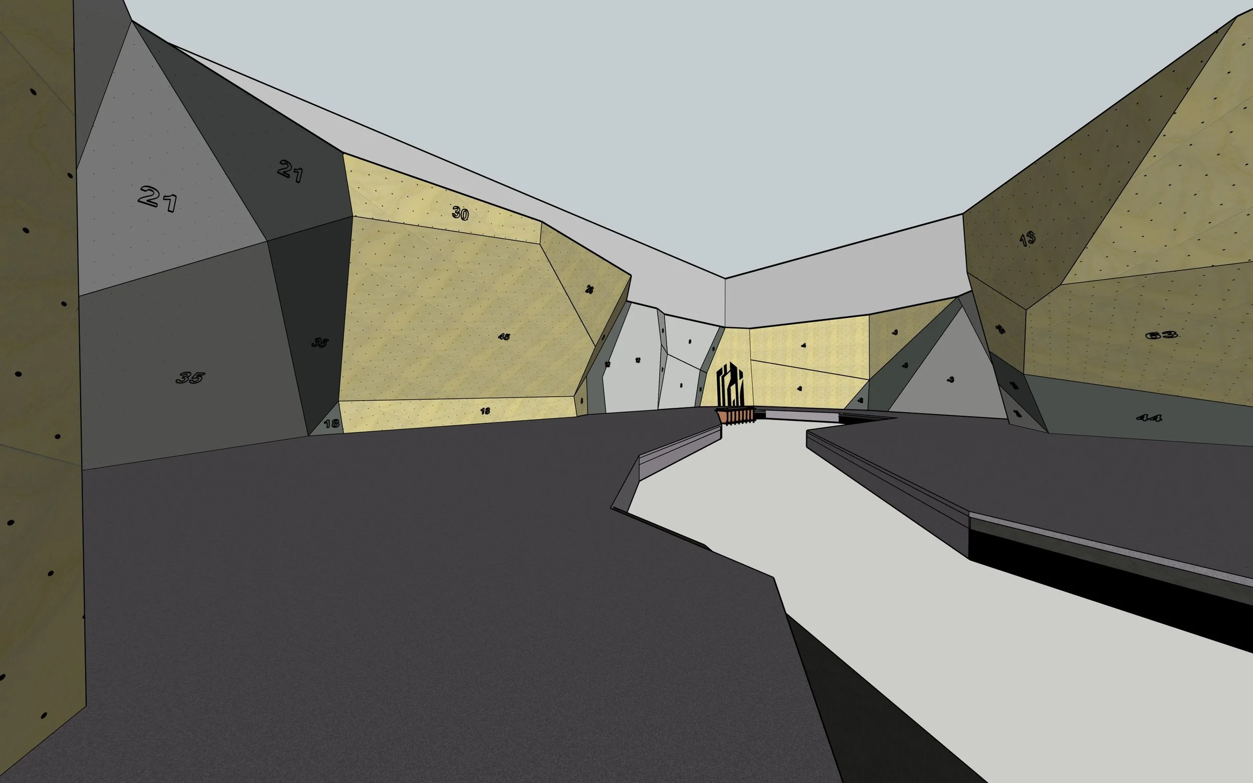 Interior view of a modern rock climbing gym with various colored holds and numbered climbing walls.