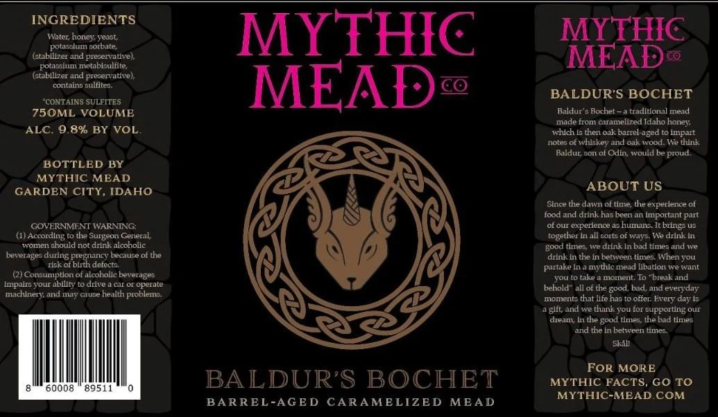Label for Mythic Mead Baldur's Bochet, a barrel-aged caramelized mead, with ingredients, alcohol content, and company information, featuring a central logo of a goat's head in a Celtic knot design.