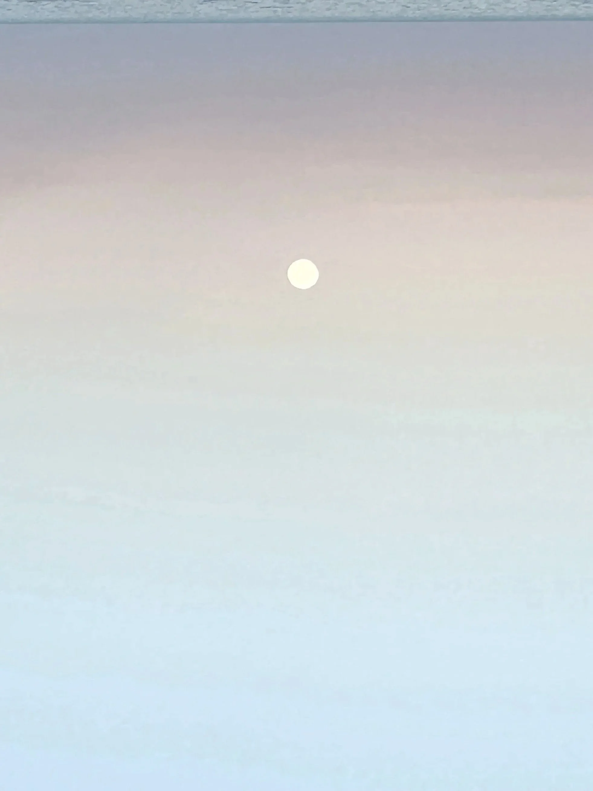 A white moon in a pastel-colored sky with gradients of purple, pink, and blue.