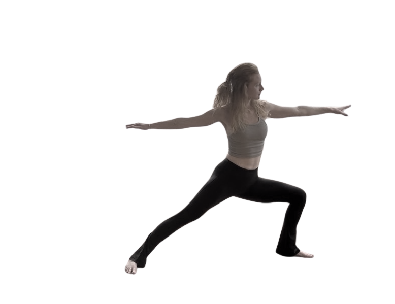 A woman practicing yoga in a Warrior II pose, standing with legs wide apart and arms extended, in an indoor setting.