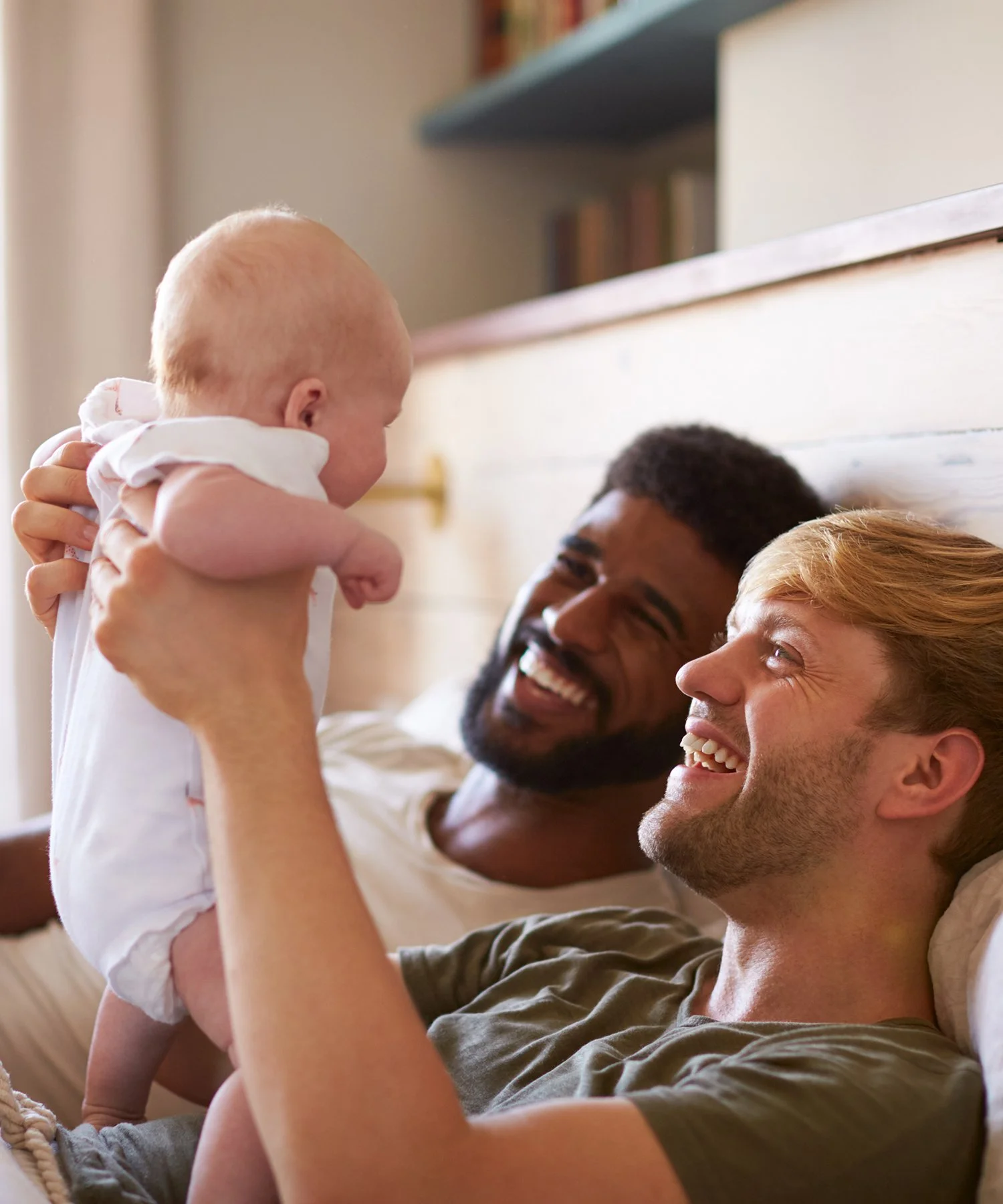Two parents, one is holding their baby.