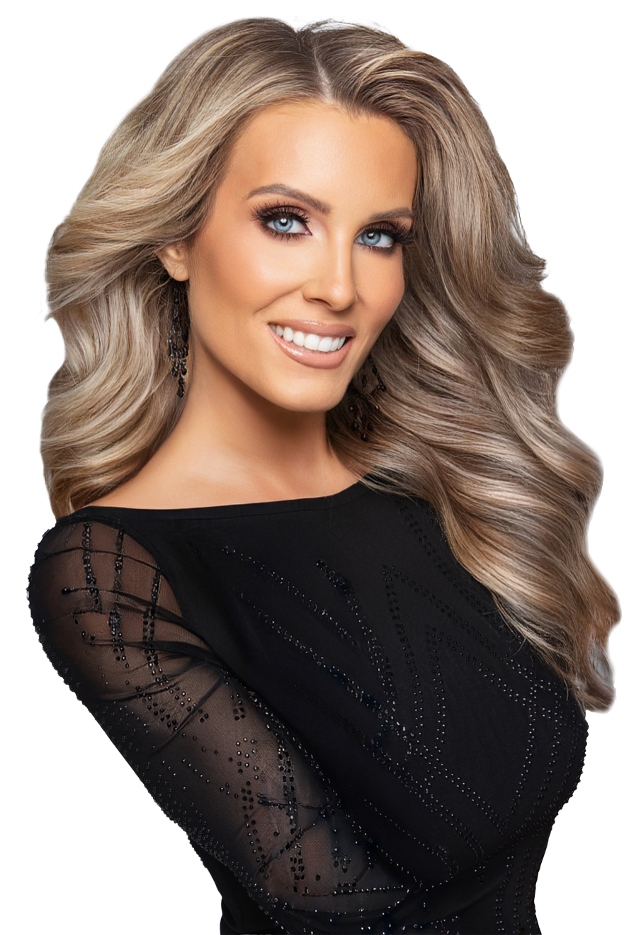 A woman with long, wavy blonde hair and striking blue eyes is smiling at the camera. She is wearing a black top with sheer, embellished sleeves and dangling earrings.