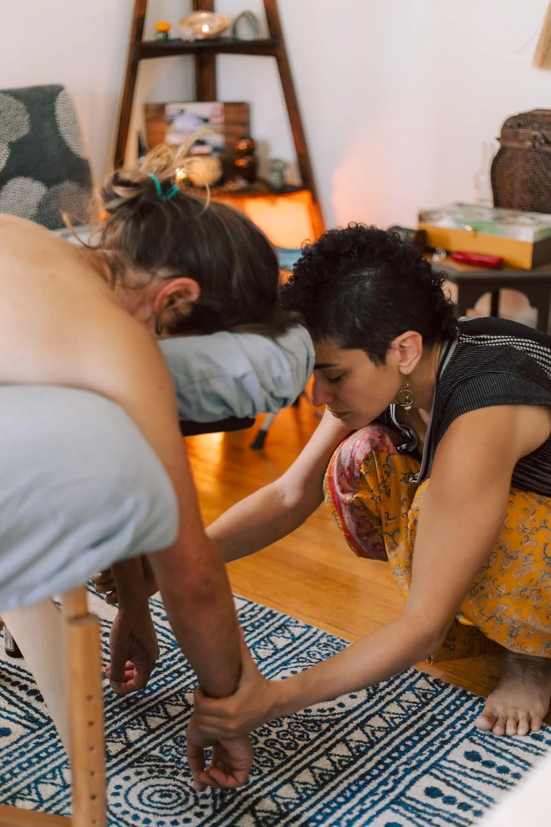 Nelly Bablumian LMBT holds client's arms in massage and energy healing session