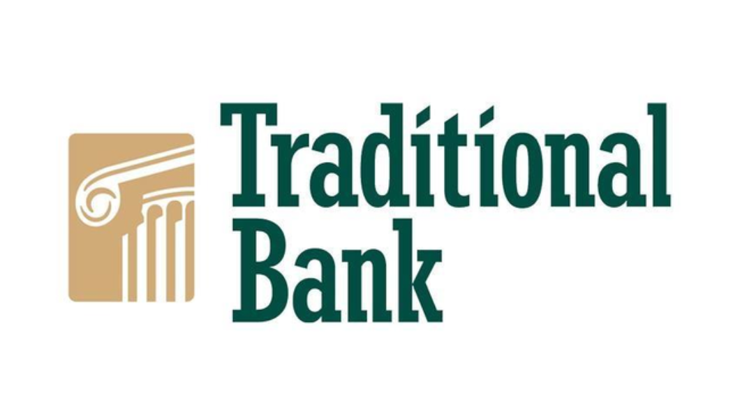 Logo of Traditional Bank featuring a gold-colored column and green text.