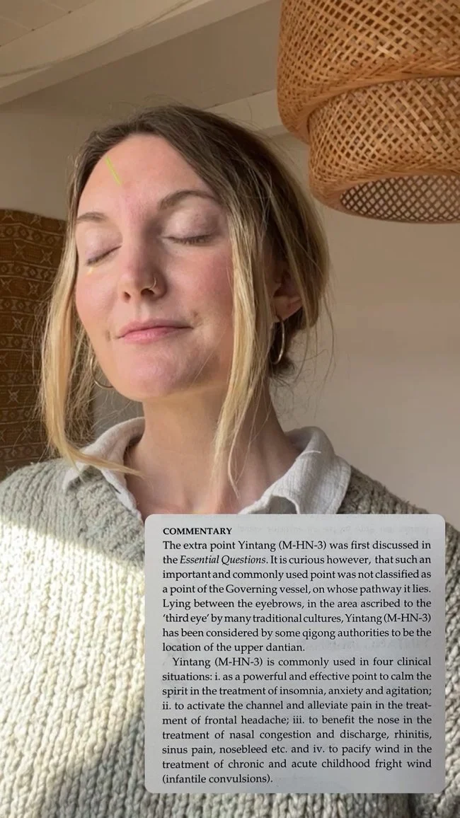 Yintang (M-HN-3) point on her forehead.