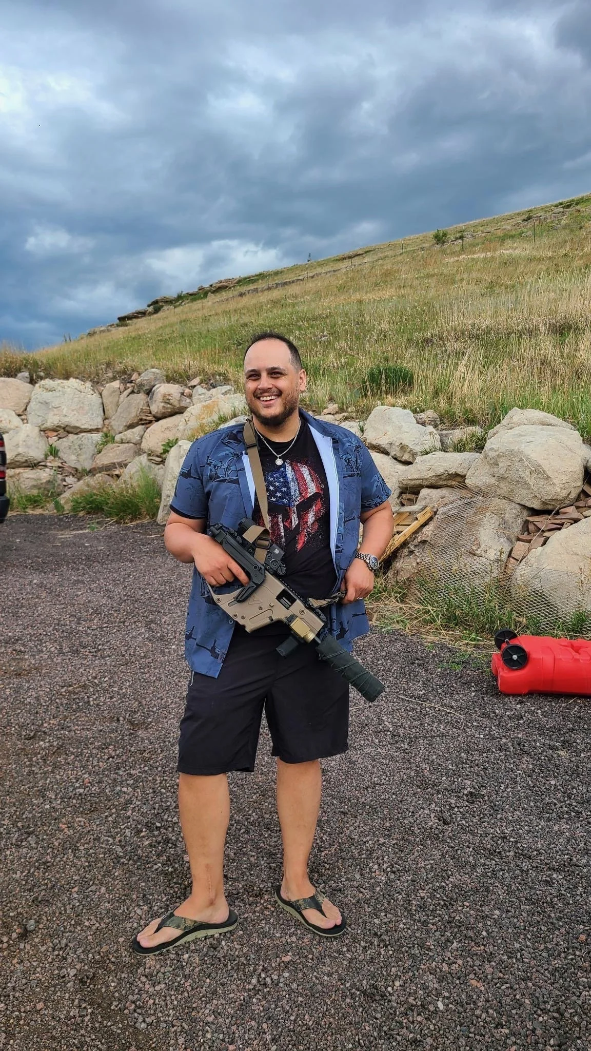 Teddy Collins, Candidate for Colorado State Senate District 4 holding a firearm at an outdoor venue.