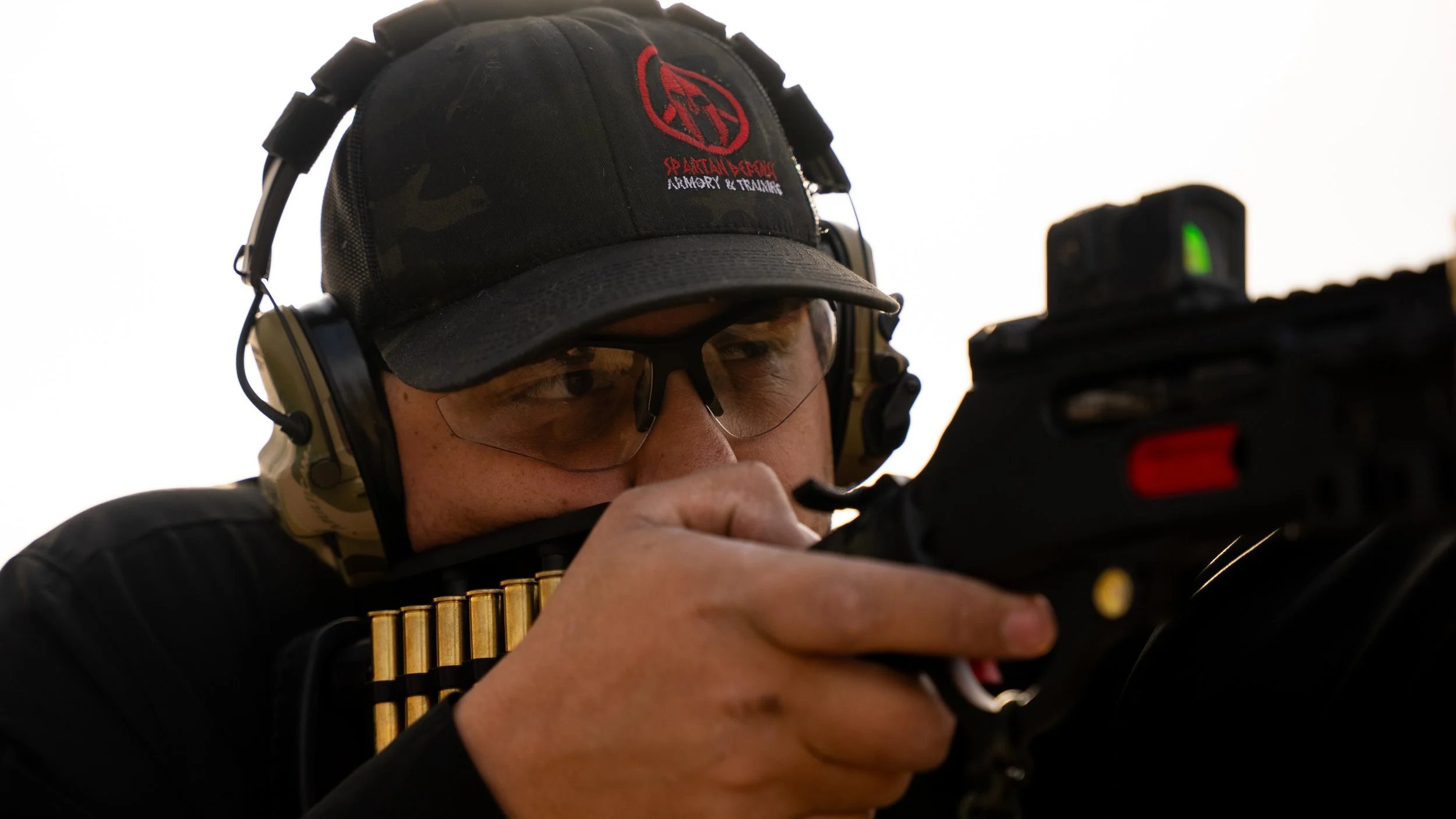 Teddy Collins, Candidate for Colorado SD 4, aiming a firearm with a mounted scope.