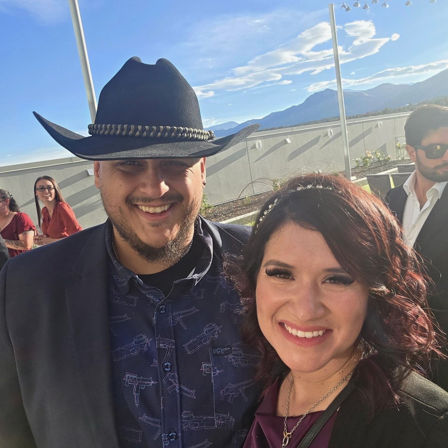 Teddy Collins, Candidate for Colorado State Senate District 4 and his wife post for a selfie at an outdoor event.