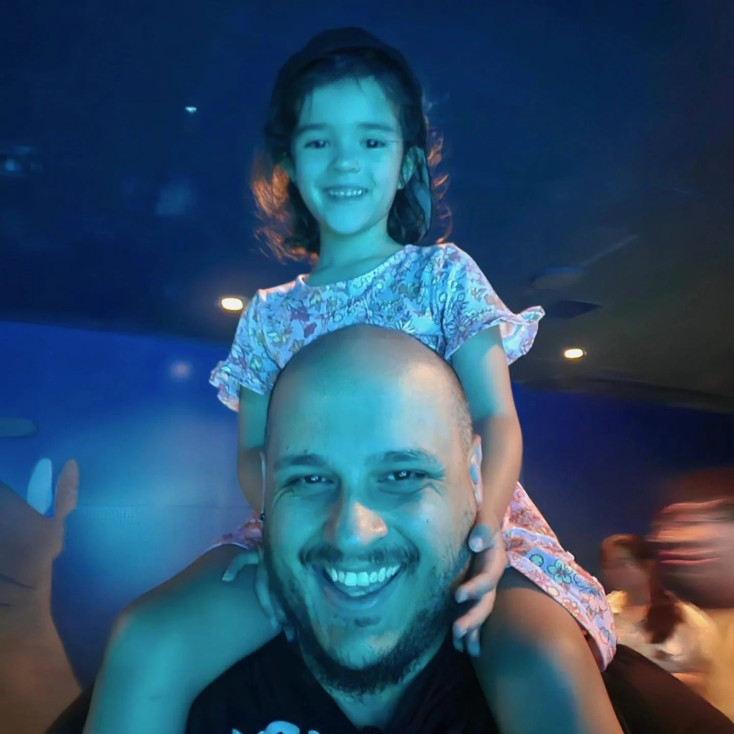 Teddy Collins, Candidate for Colorado State Senate District 4 smiling, carrying a his daughter on his shoulders.