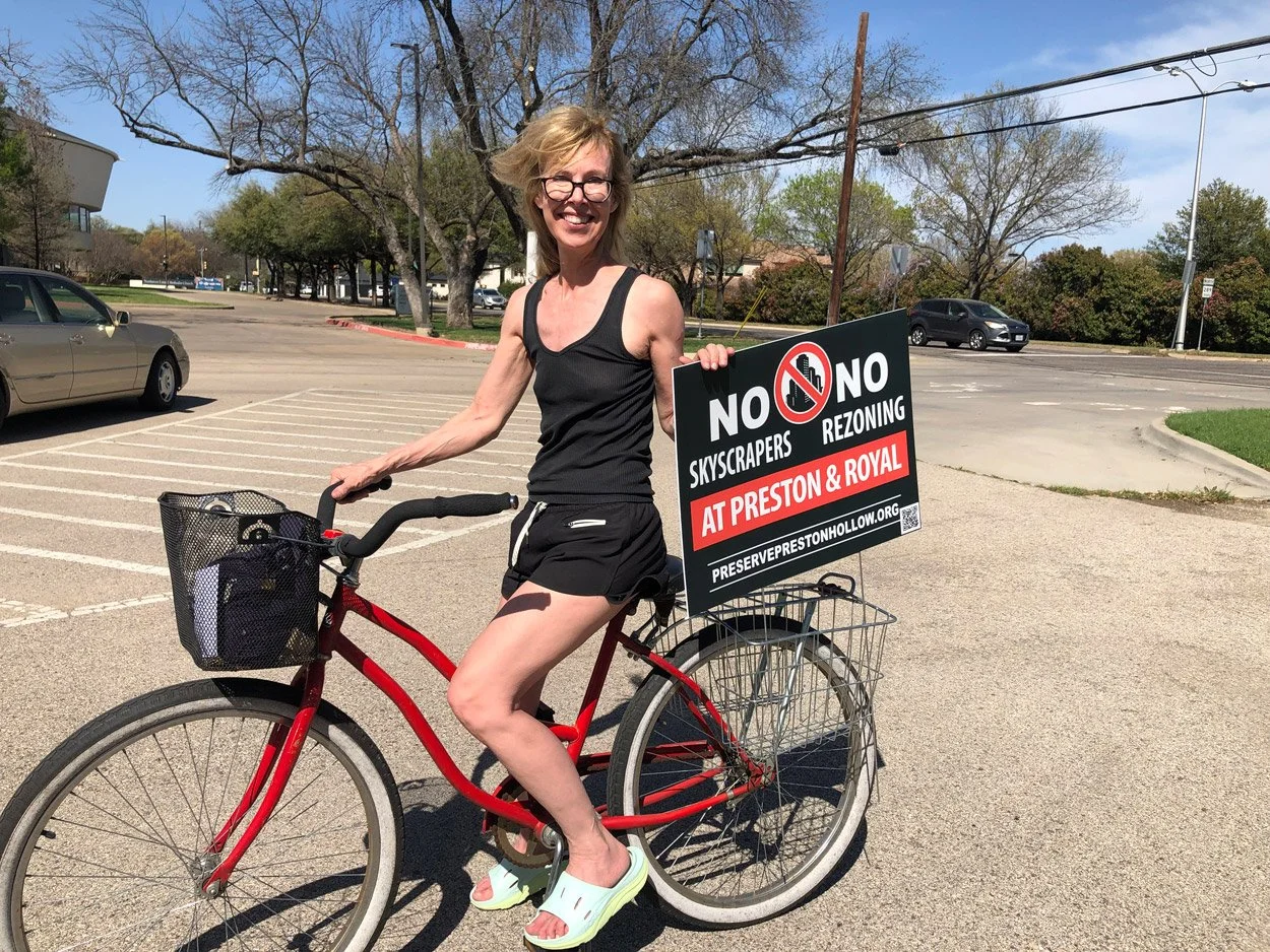 Cyclist Jean of Elderwood Drive sports her No Skyscrapers yard sign