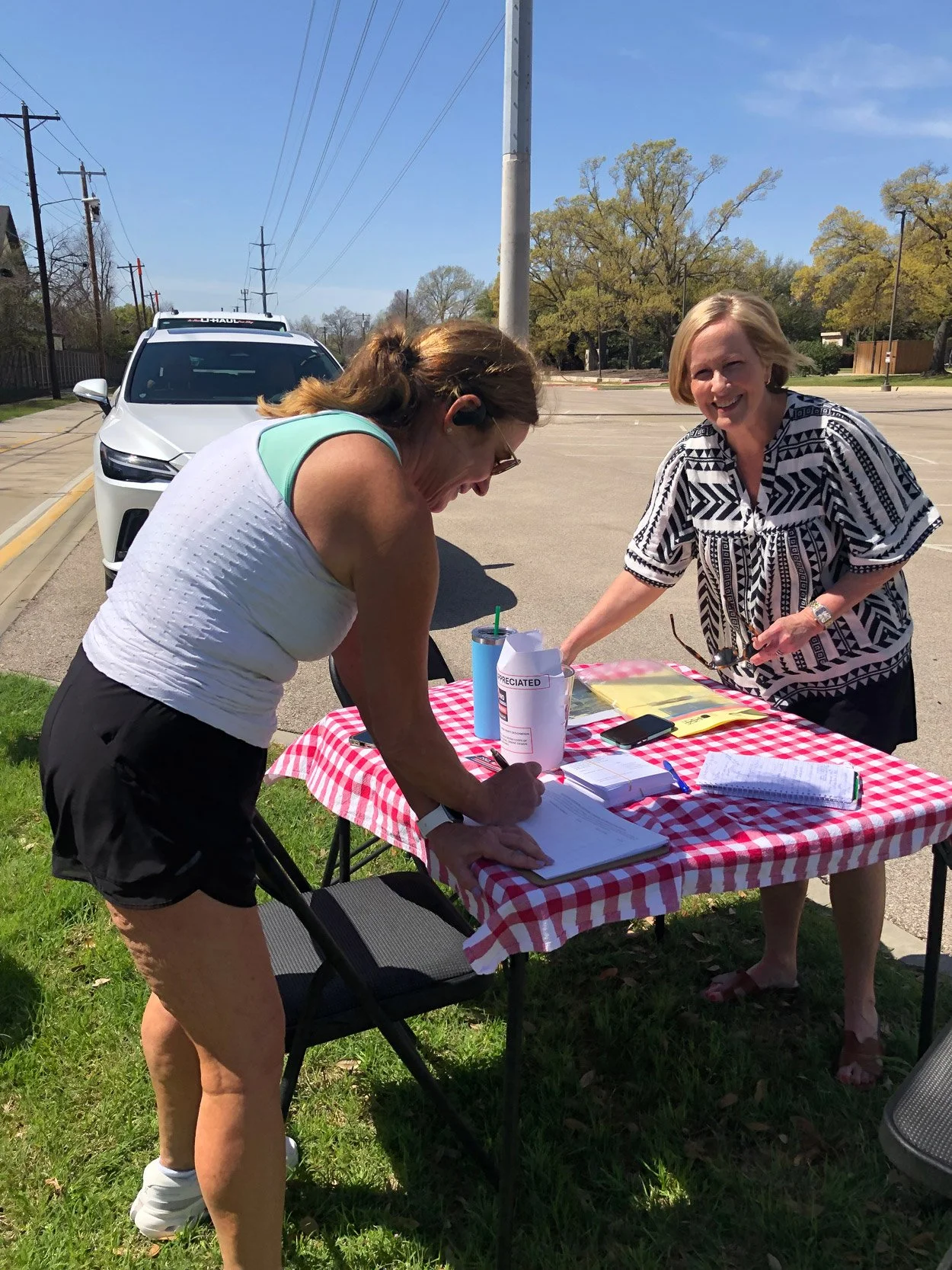 Currin Drive resident, left, signs petition with PPHC member at Northaven Trail