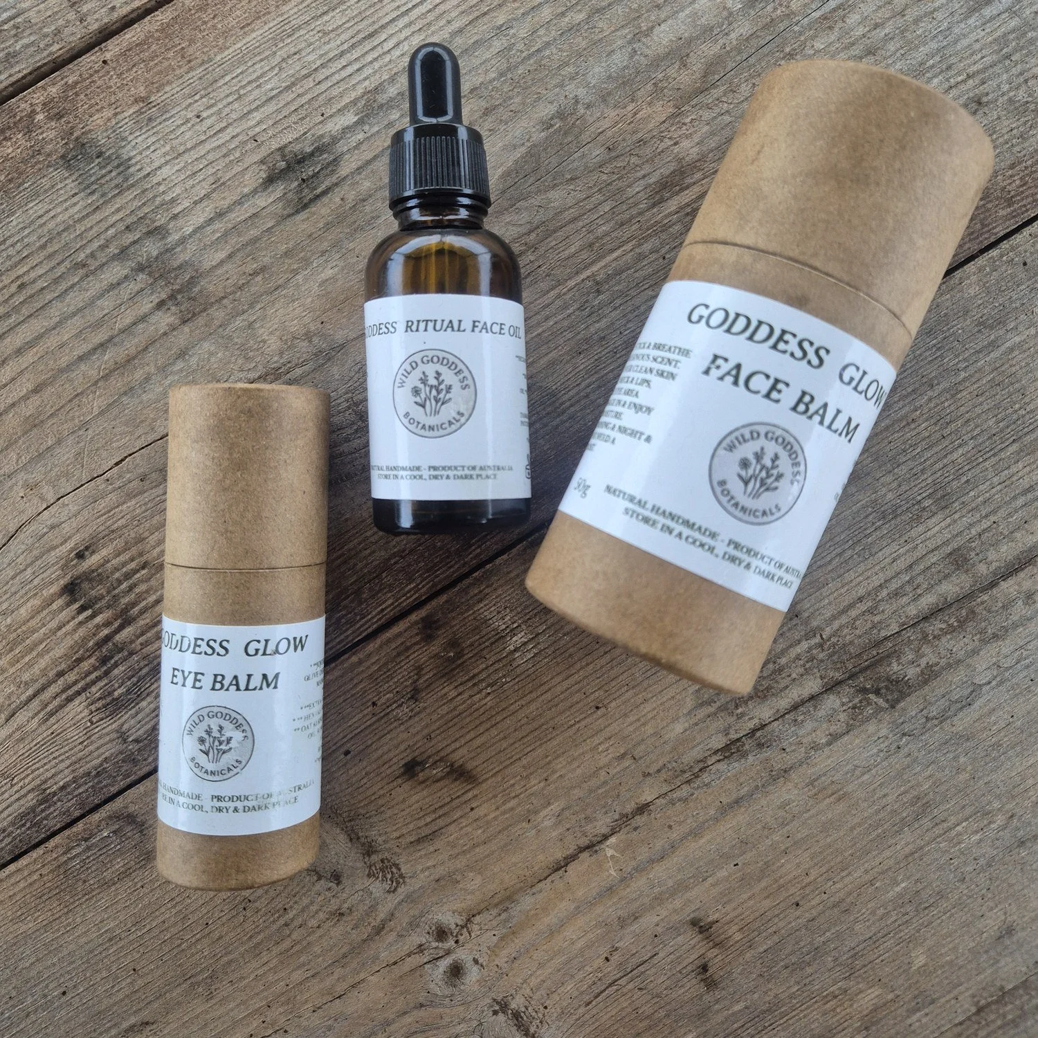 The Ritual Set laid out on weathered timber — Goddess Glow Face Balm, Goddess Ritual Face Oil and Goddess Glow Eye Balm