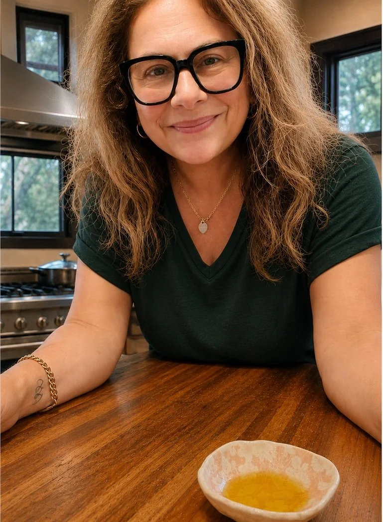 Sonia Karouzos, founder of Wild Goddess Botanicals, at her kitchen bench with a bowl of oil