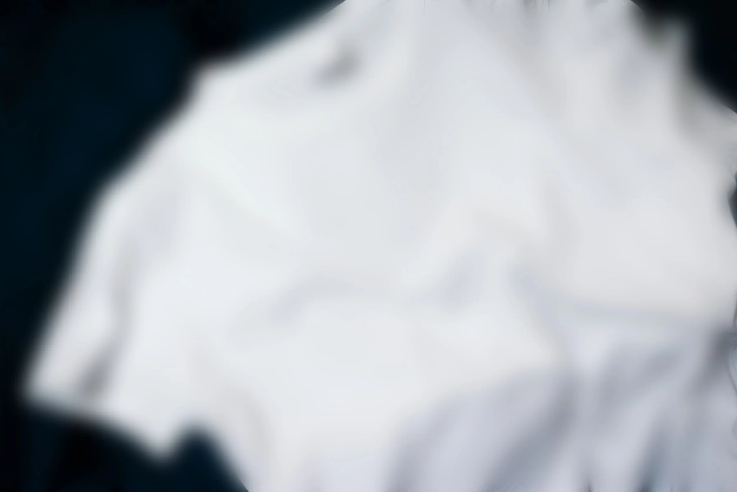 blurry image of a t-shirt meant to show that the product cannot be revealed yet.