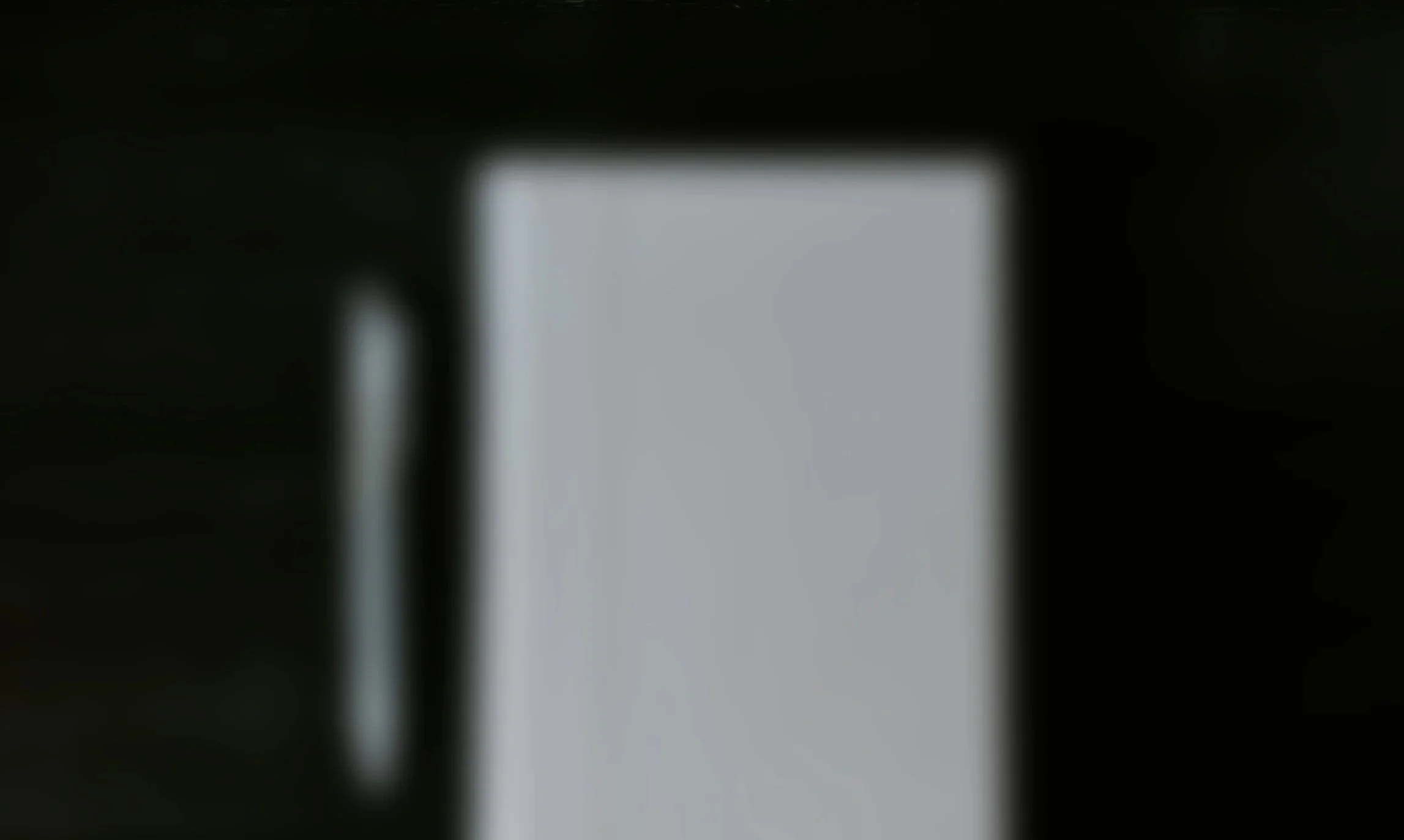 blurry image of a pen and notebook meant to show that the product cannot be revealed yet.