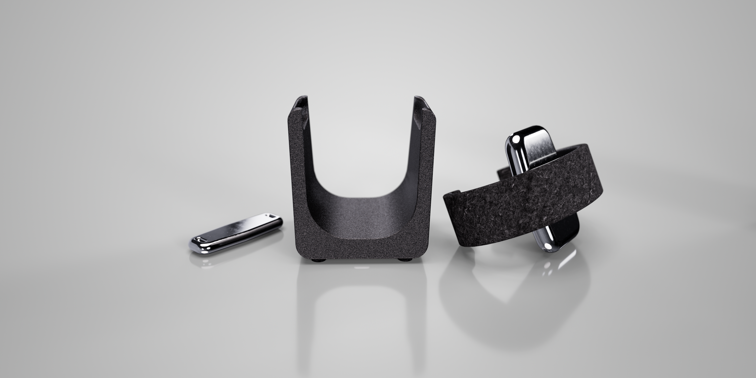The watch sys components separated with the U shaped base in the middle, the thin metal spacer on the left, and the carrier on the right