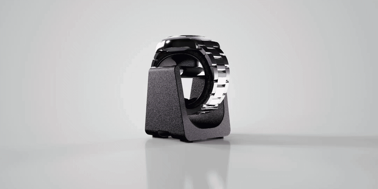 A black and silver wristwatch on a grey display stand.