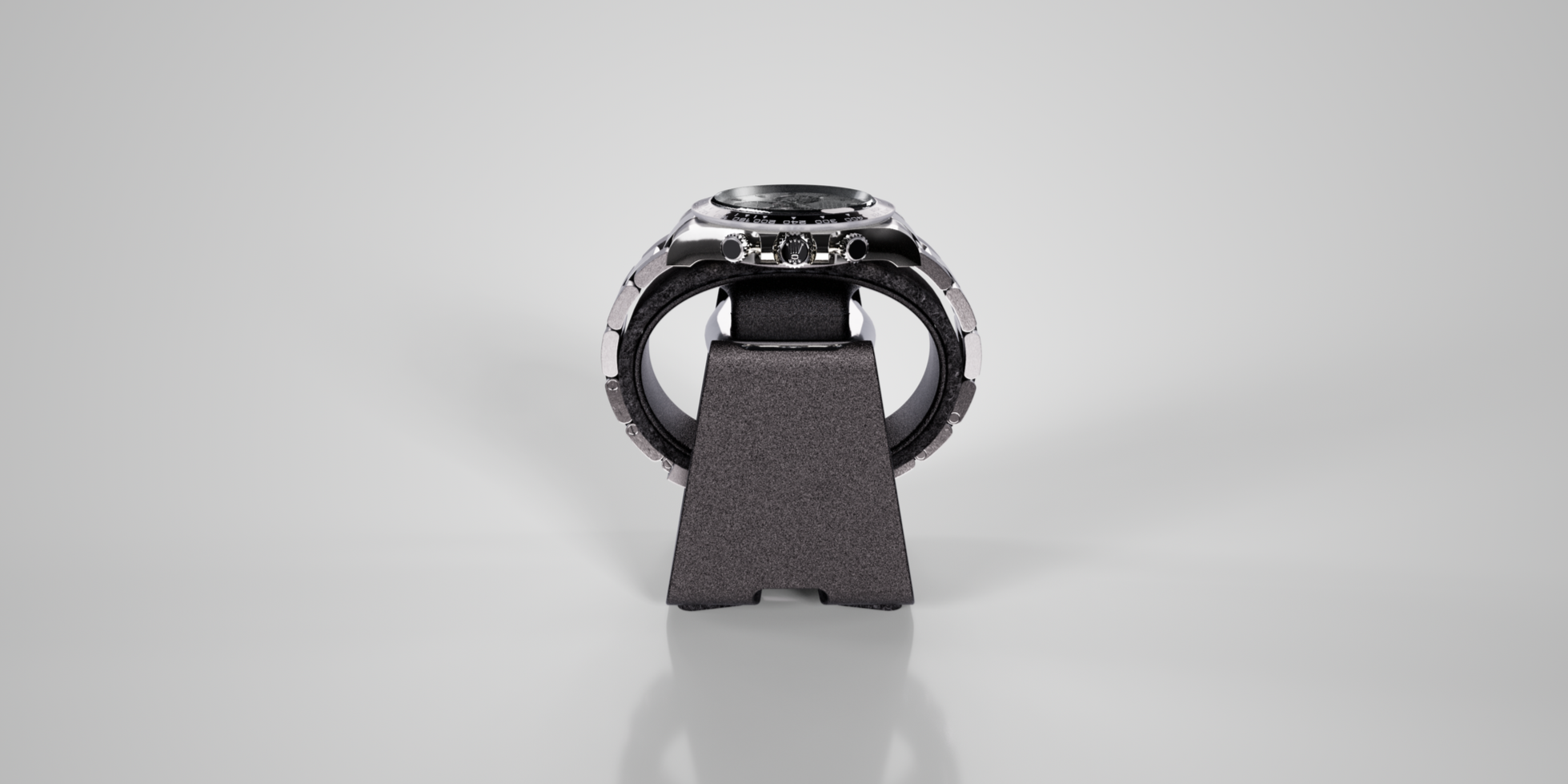 A wristwatch with a metallic case and black strap, placed on a black stand against a plain light gray background.