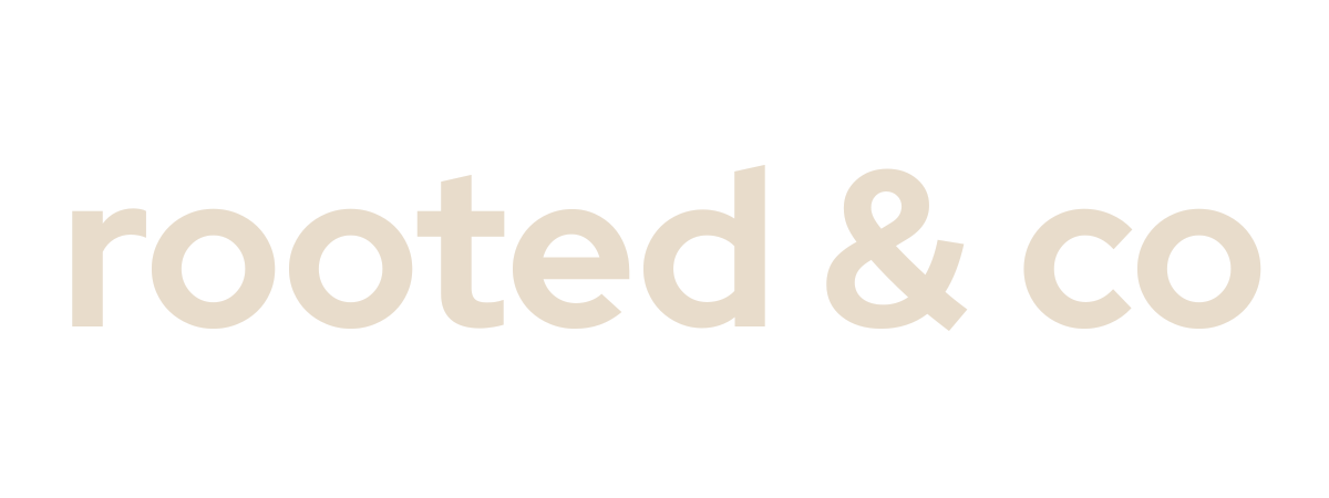 The image displays the words "rooted & co" in beige lowercase letters on a black background.
