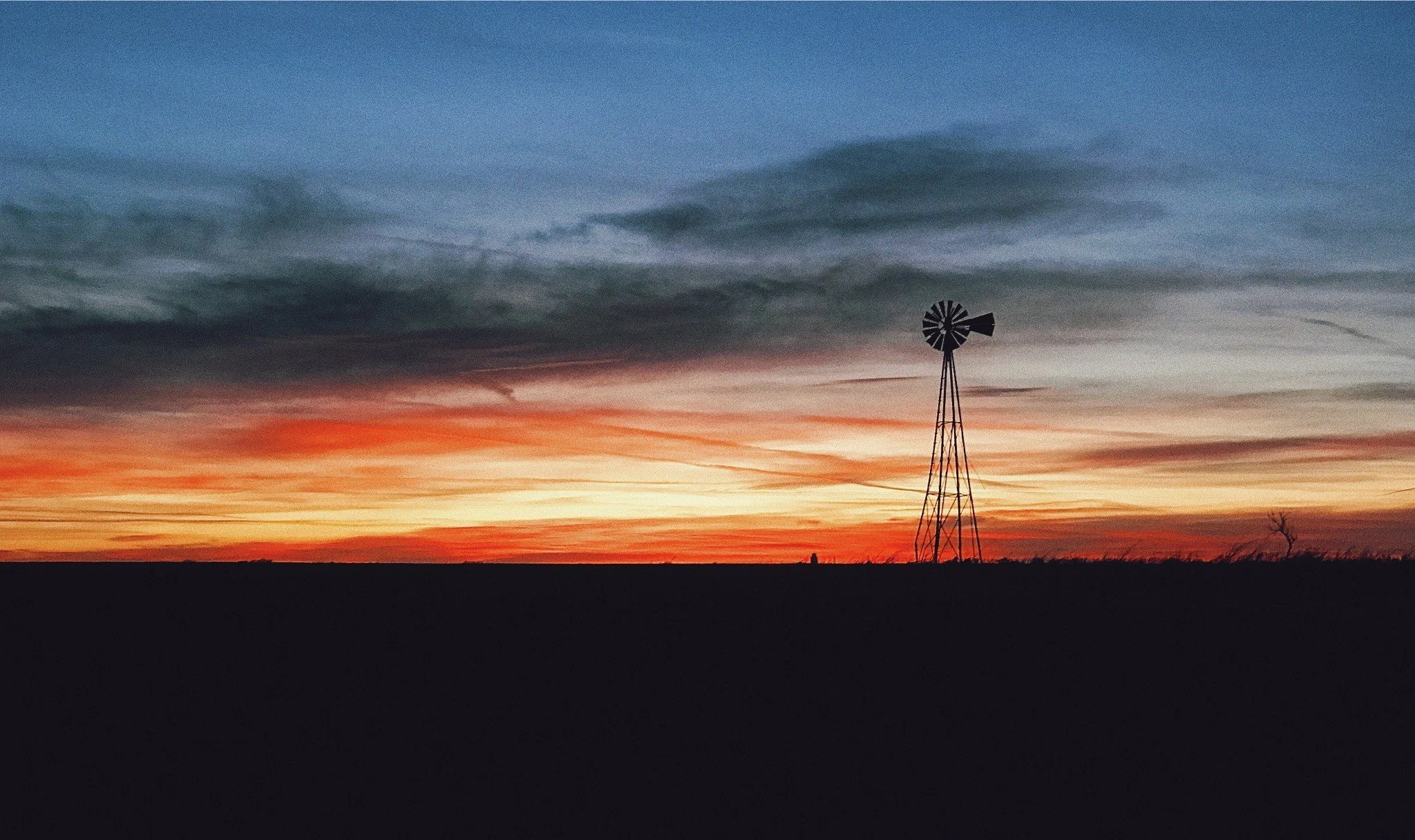 An Oklahoma sunset with a windmill on the horizon.