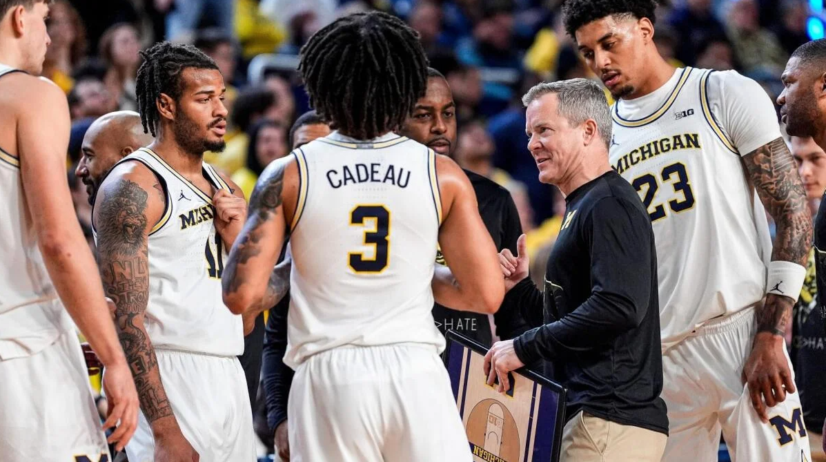 Michigan Wolverines Head Coach Dusty May huddles with his players during a timeout of the 2026 National Championship Game against the UConn Huskies.