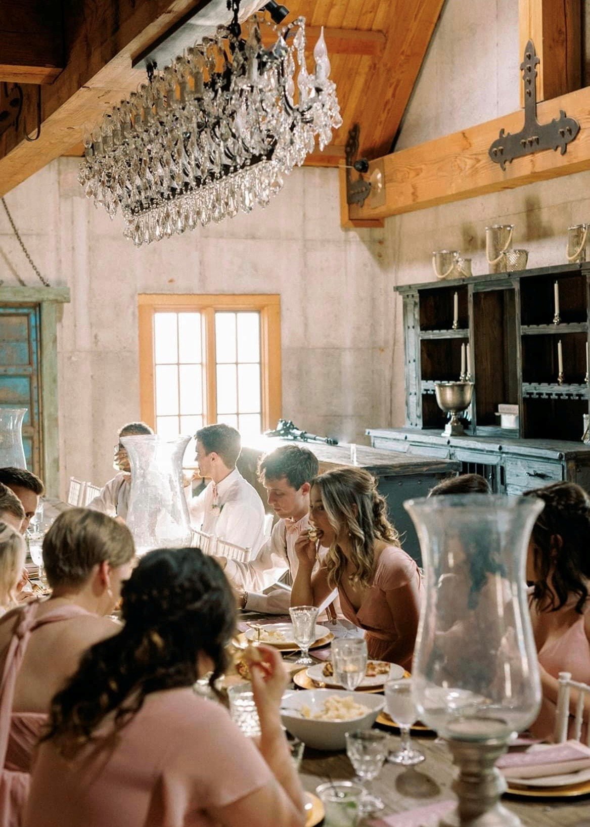 A wedding party enjoys a private meal together at a wedding.
