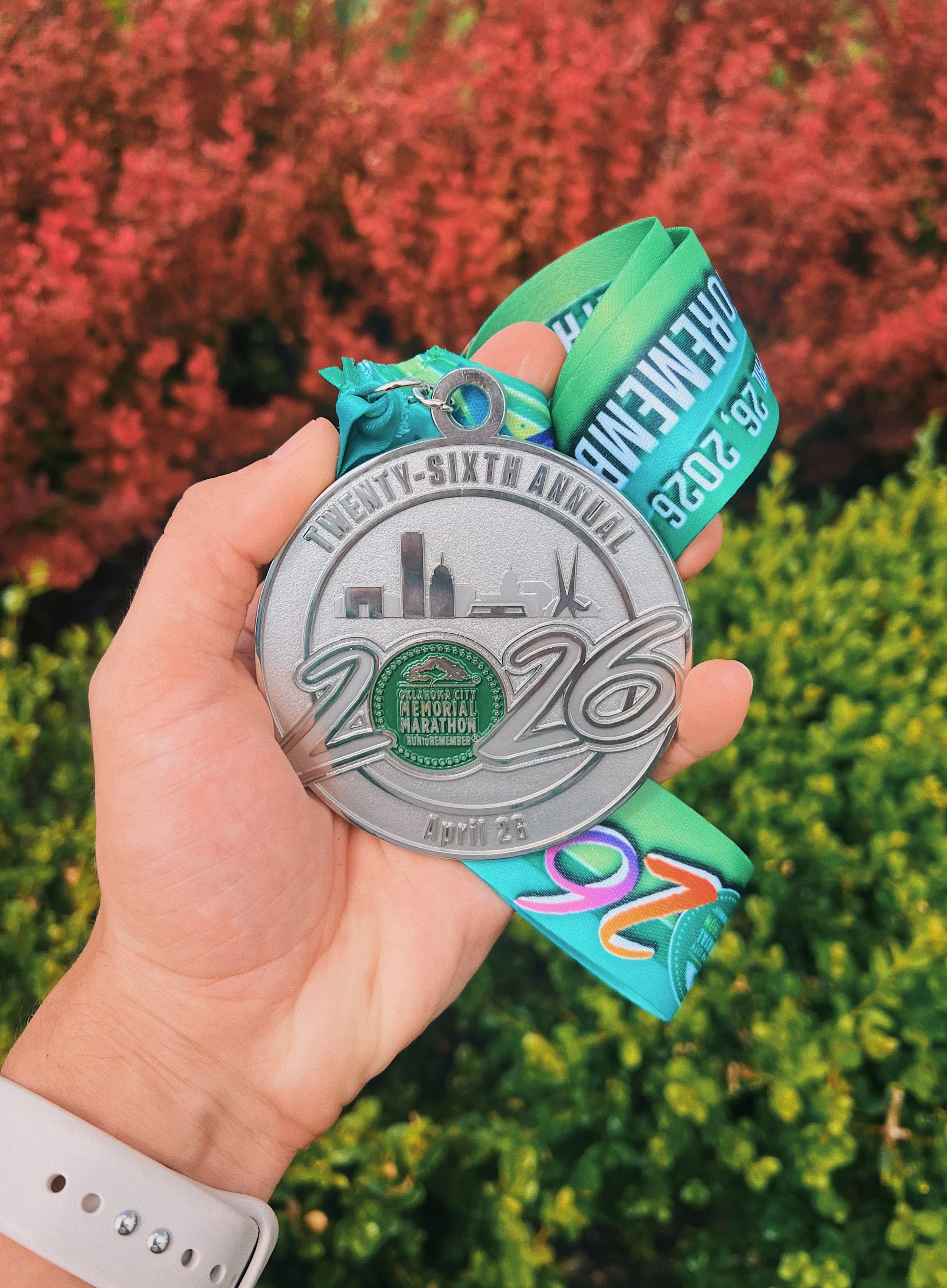 Kevin Severin holding a Oklahoma City Memorial Marathon medal.