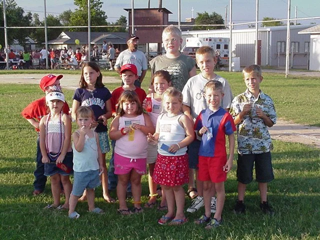 Kevin Severin standing with other children with his 1st place ribbon.