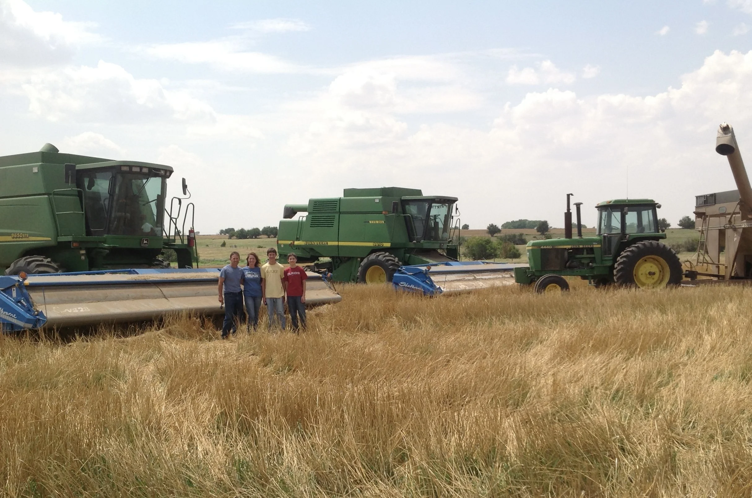 Kevin Severin and his family surrounded by harvest equipment.