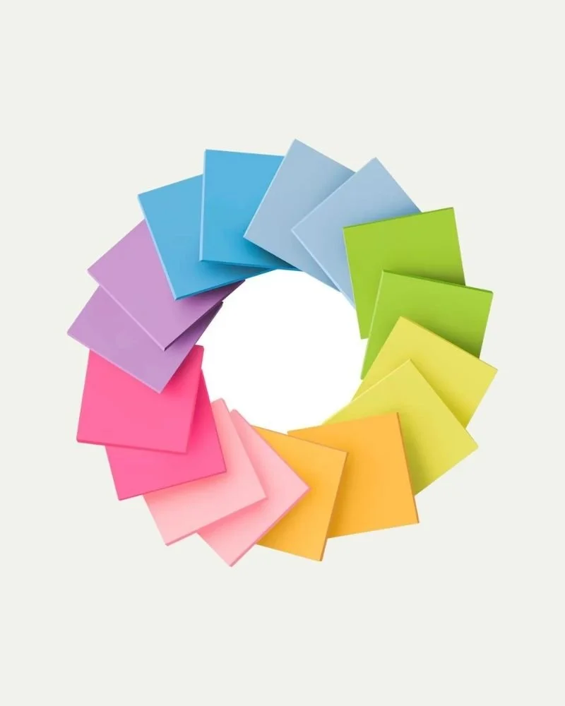 Colorful paper or sticky notes arranged in a rainbow-colored circular pattern.