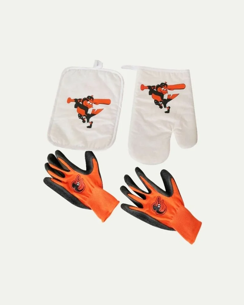 A set of Baltimore Orioles-themed sports gear including a pair of gloves, oven mitt, and pot holder, all with the team mascot and logo.