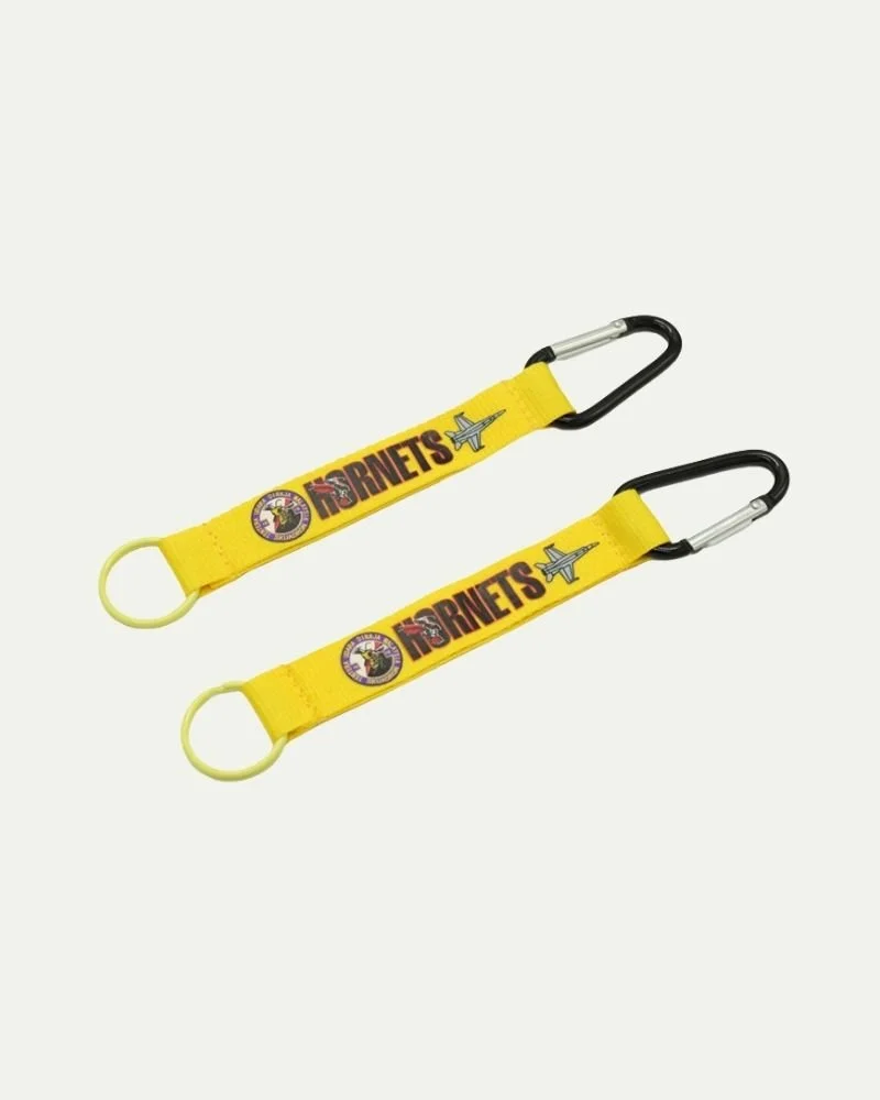 Two yellow luggage strap tags with airplane and 'FISNETS' logo, attached to black and silver carabiners.