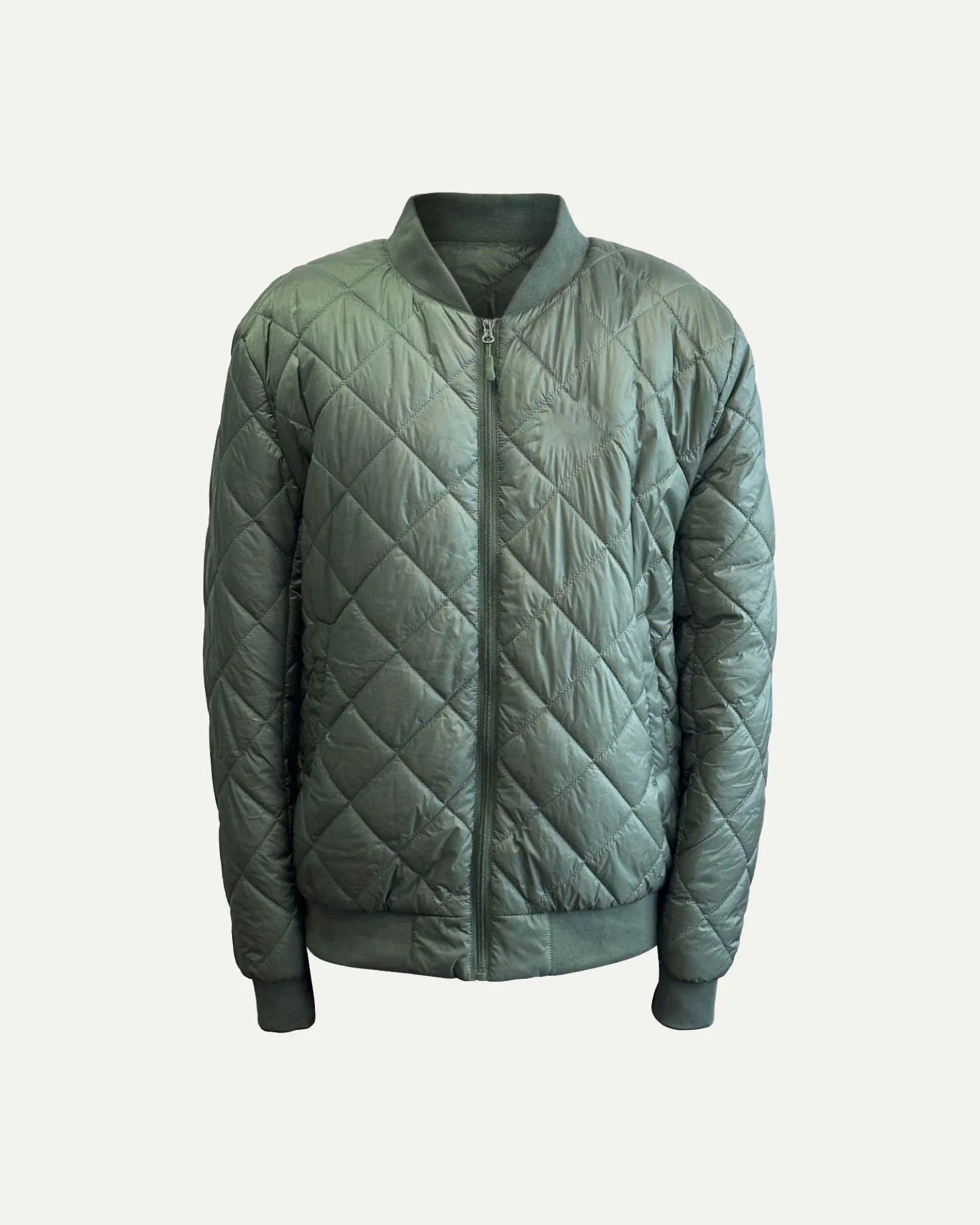 Green quilted men's bomber jacket with front zipper, ribbed collar, cuffs, and hem, on a neutral background.