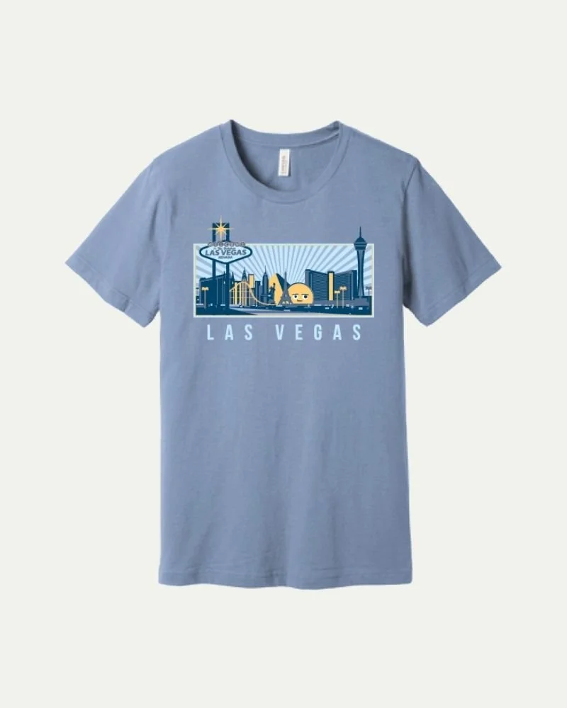 Gray T-shirt with a graphic of Las Vegas skyline, including the Stratosphere Tower, a roller coaster, and a casino sign, with "LAS VEGAS" written below.
