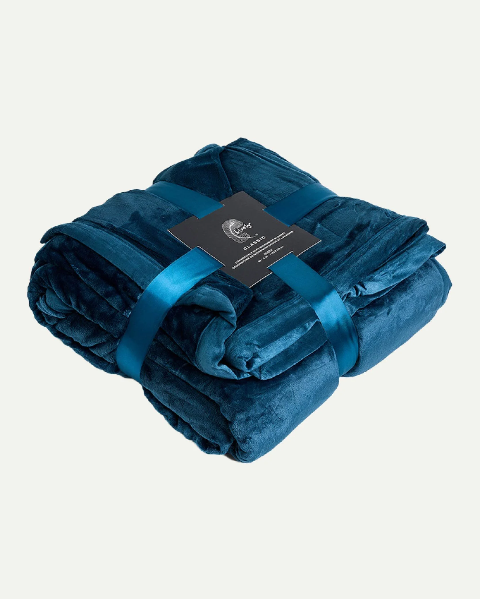 A folded blue velvet blanket secured with a blue ribbon and labeled with a black tag.