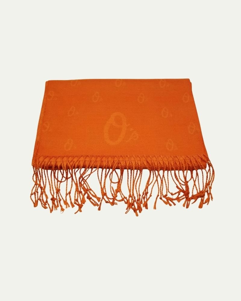 Orange scarf with fringe on a white background.