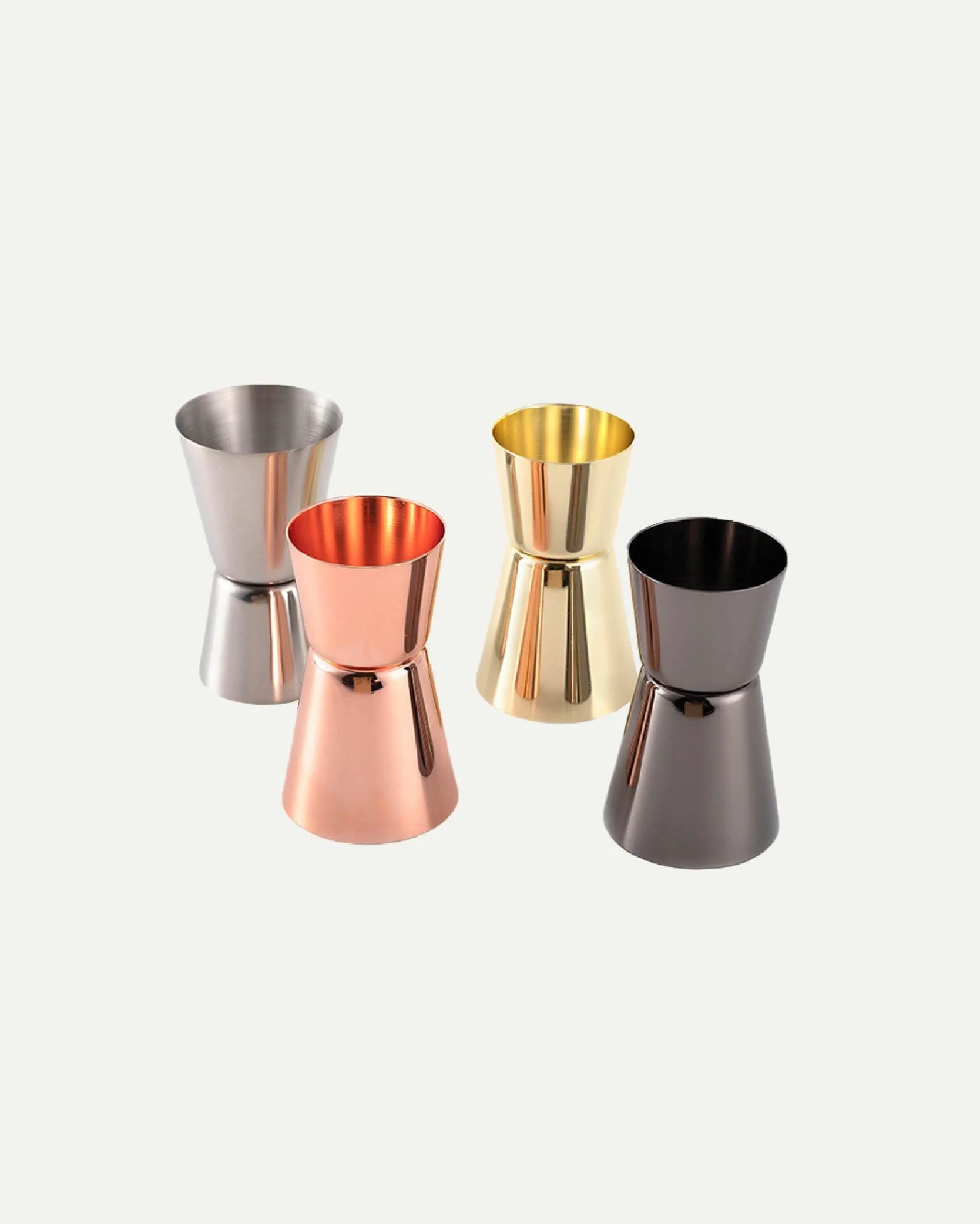 Four metallic jiggers in silver, rose gold, gold, and black, arranged in a semi-circle on a plain light background.